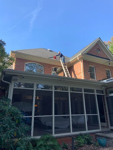 MetaClean Services LLC technician performing residential pressure washing on a Charlotte NC home